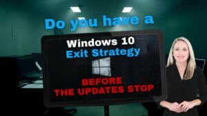 Dark and empty office in the. background. Computer screen displaying the Windows 10 icon. Spokes woman standing in the foreground. Image text: Do you have a Windows 10 Exit Strategy Before the Updates Stop.
