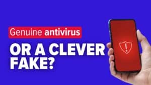 Hand holding smart-phone that is displaying a security warning symbol. Image text: Genuine antivirus&mdash;or a clever fake?
