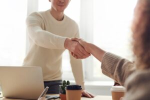 Man Woman Near Table Shaking Hands