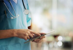 Medical Dr holding tablet while pointing at the screen