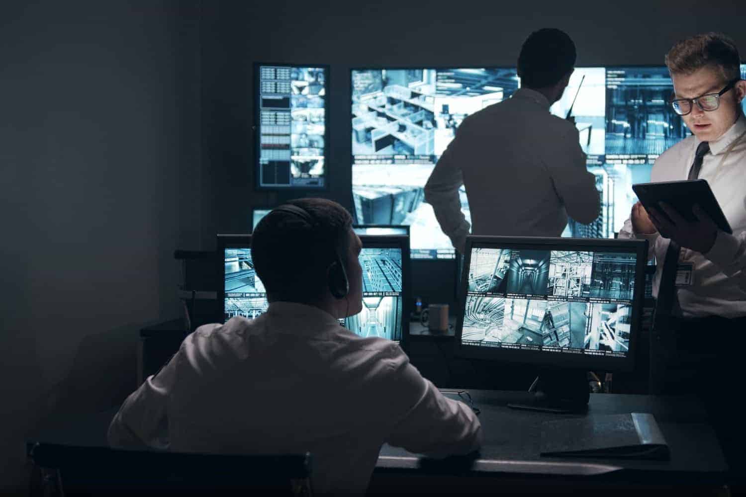 Police Officers Monitoring Security Camera while Looking at the Monitor Screen